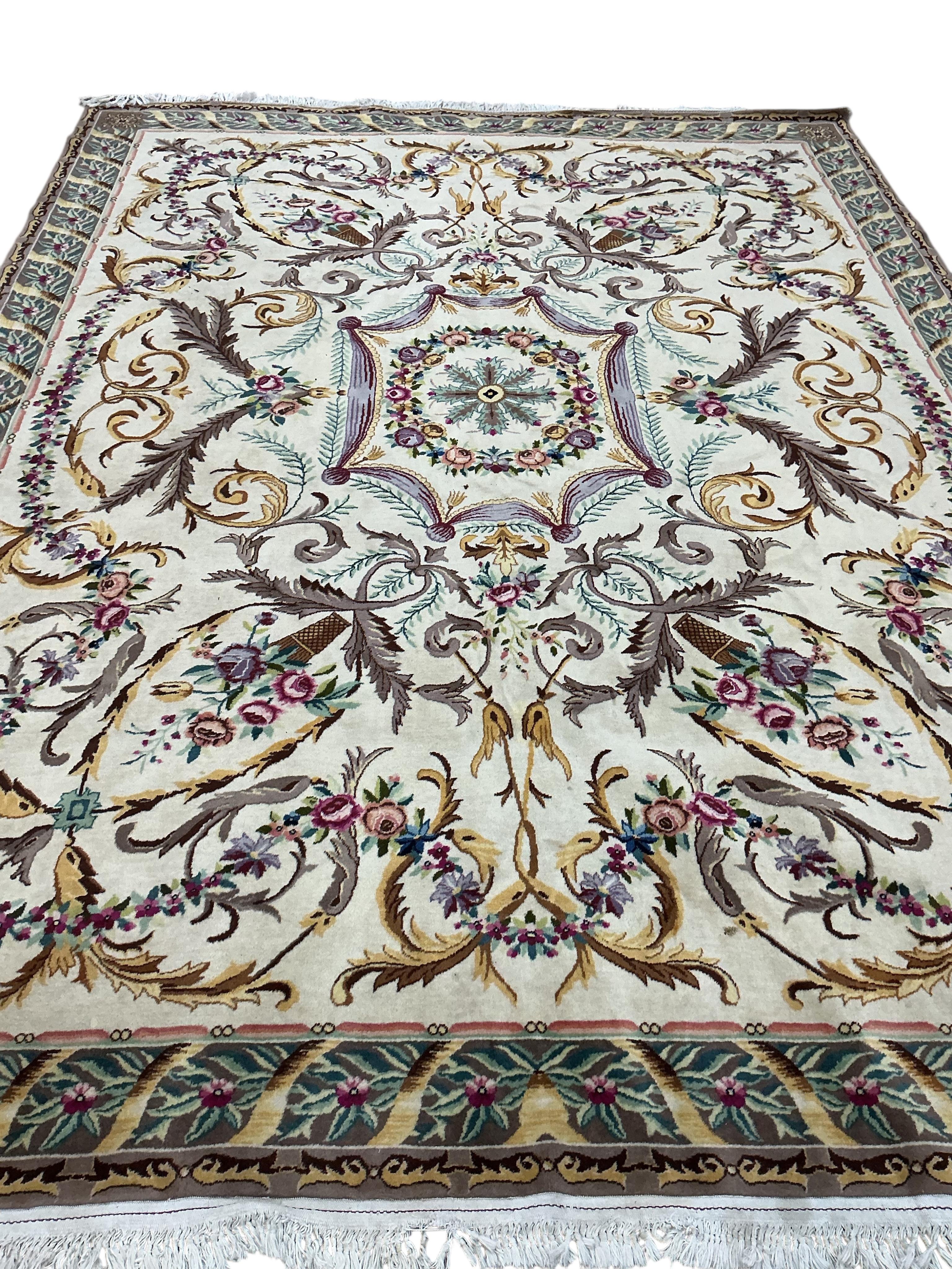 An Aubusson style ivory ground carpet, 325 x 245cm